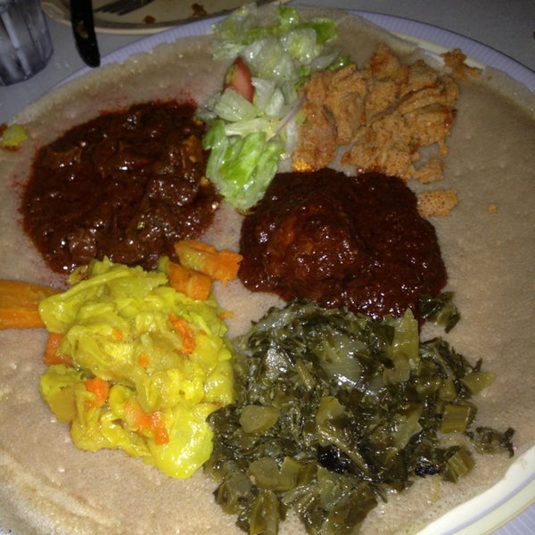 Photo taken at Messob Ethiopian Restaurant by Cathy C. on 8/31/2013