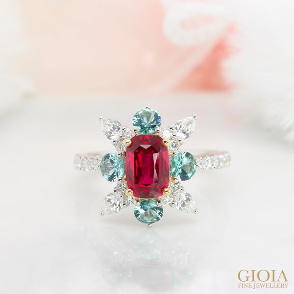 Ruby – 40th Wedding Anniversary Designed with diamond and bluish green Tourmaline surrounding the Pigeon Blood Ruby gem. Ruby is believed to possess an eternal flame that signifies a strong marriage