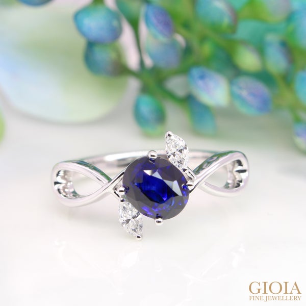 Royal Blue Sapphire Engagement Ring Featuring a vivid blue sapphire, designed with twisted band and marquise diamond resemble a flower bouquet.