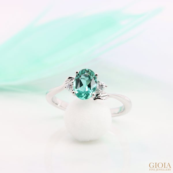Lagoon Tourmaline Engagement Ring Featuring a bluish-green lagoon shade tourmaline gem. Crown with side round brilliance diamond and natural leaves detailings.