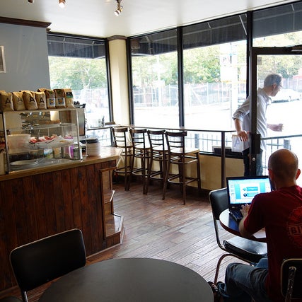Owner-operated shop w/ rotating cast of coffee roasters and baked goods from their restaurant across the street. Coffee is consistently good and wifi is steady. Wall tables all have plugs.