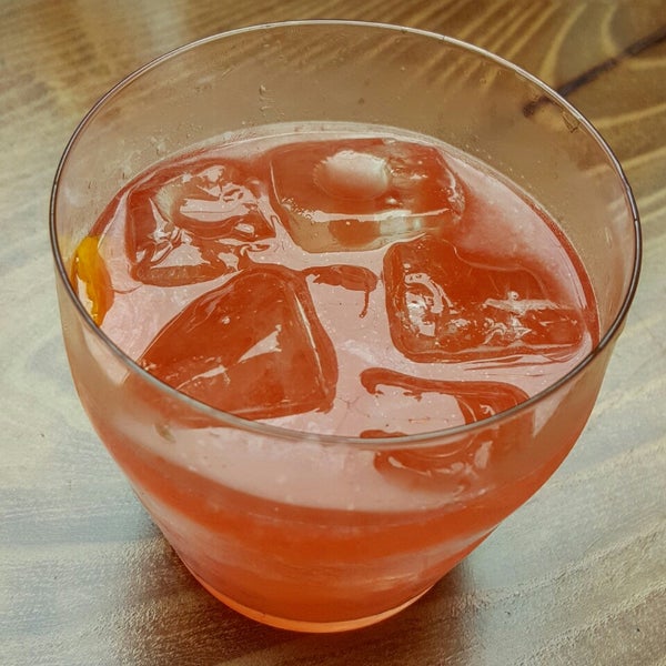 The Fancy Lil Piglet is a great summer cocktail made with Pig's Nose Scotch, Lillet, grapefruit, Campari, and peach bitters.