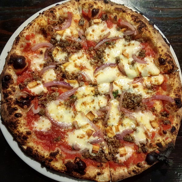Encore pizza is full of flavor with smoked mozzarella, sausage, red onion, & oregano.