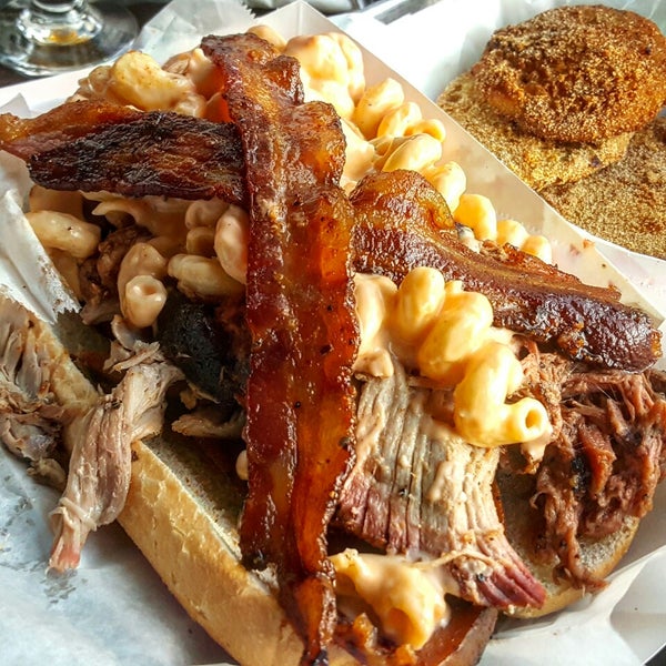 If you're bold enough, order the massive The Belly Buster sandwich which consists of smoked bologna, 1/2 lb pulled pork, 1/2 lb chopped brisket, mac & cheese, and topped with candied bacon.