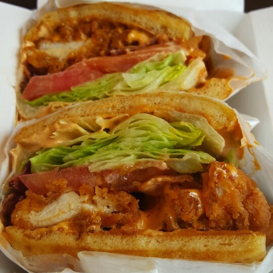 The Poppa Bear waffle sandwich doesn't mess around! Loaded with fried chicken breast, bacon, tomato, lettuce, provolone, and topped with chipotle sauce. Go get it!