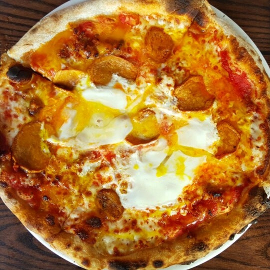 The oozy delicious Breakfast Pizza is the highlight of their brunch menu, topped with eggs, cheddar,‏ sausage, & potato.