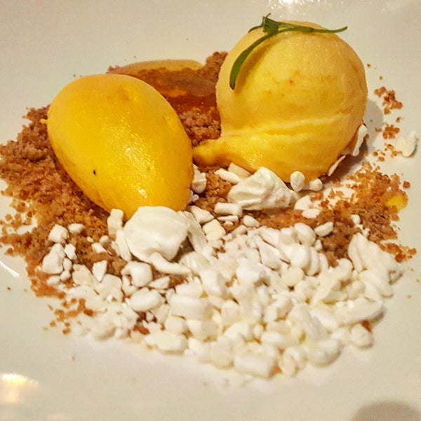 How do you top off an excellent dinner? You order the Deconstructed Aji Amarillo Cheesecake made with oatmeal candy, salty caramel, aji amarillo mango gelato orange marmalade topped with micro mint.