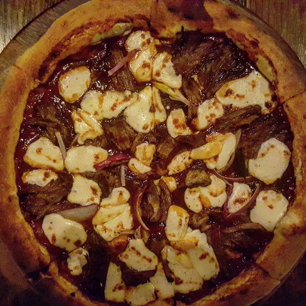 Grab a flight of beers ansld enjoy the sweet & savory wood-fired Braised Short Rib pizza made with bbq sauce, smoked mozzarella, & red onions.