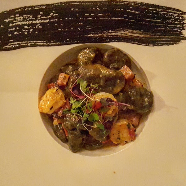 Beautifully plated and equally delicious Black Gnocchi with lobster cream, roasted peppers, Andouille sausage, & rock shrimp is a great starter!