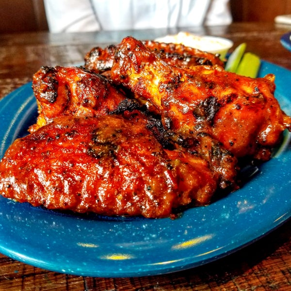 Amazing Jumbo BBQ Chicken Wingsspice-rubbed, pit-smoked, grill finished with hot Wango Tango sauce served alongside blue cheese dressing, & celery sticks.