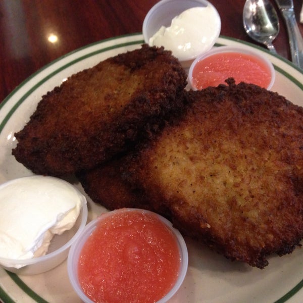 The latkes here are huge. One is the size of a burger patty. It's served with sour cream and cherry apple sauce.