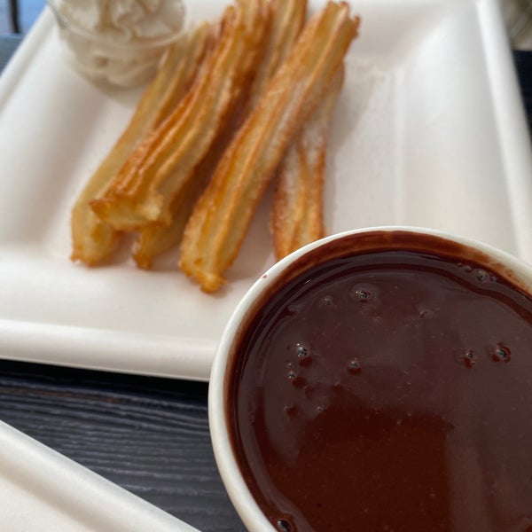 They specialize in Venezuelan food. The arepas are good. The black beans are hearty and delicious. The churros come with a thick, dark and rich chocolate drink. Only metered street parking.
