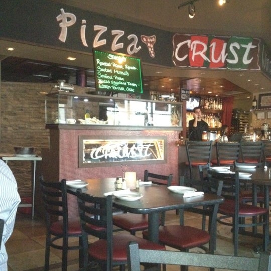 Photo taken at Crust Pizza &amp; Wine Cafe by Christopher K. on 2/25/2012