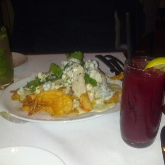 Photo taken at Wolfgang Puck American Grille by Heather J. on 12/4/2012