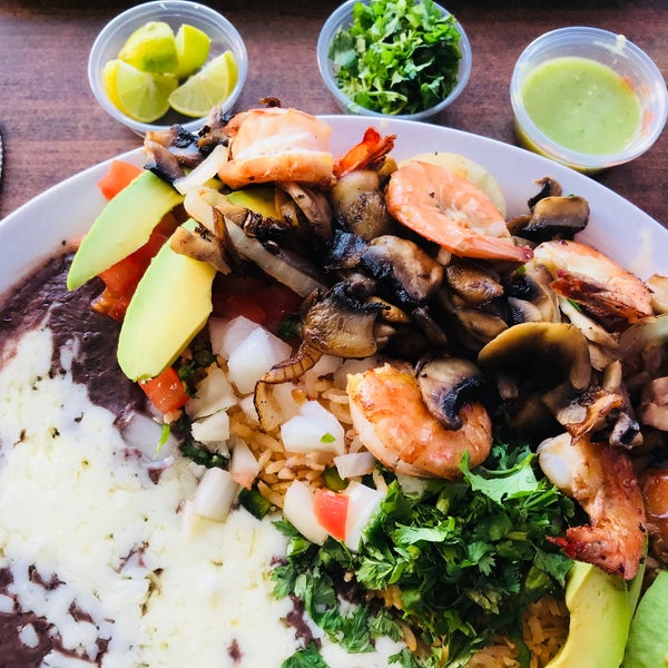 Garlic prawns come with shells on and sautéed with mushrooms and onion. Rice and selection of beans included but topped with cheese FYI $11. Extra for whole-wheat tortilla. Chips and free salsa bar.