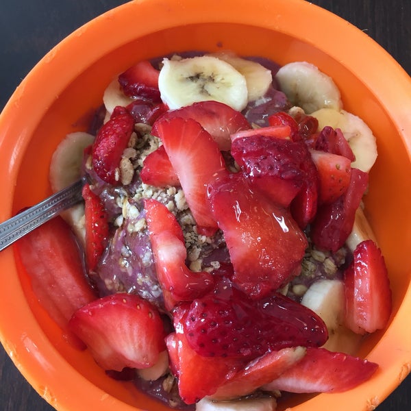 Breakfast bowl of acai, strawberries, banana, granola and bee pollen $8. Served in worn plastic bowl though