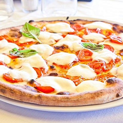 Photo taken at Pizzolis Pizzeria by PIZZOLIS P. on 4/10/2015