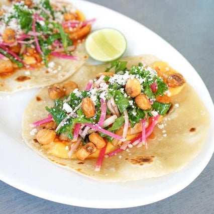 Check out the killer Spicy Squid tacos, topped with kale, apple, cotija cheese, and corn nuts.
