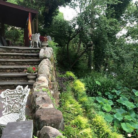 The Samadhi Garden sits along a terraced hillside, has a koi pond filled with blooming lotus flowers, stone elephants & ceramic monkeys. Winding paths allow the visitor many nooks to sit quietly.