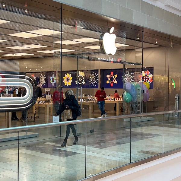 File - People shop at an Apple store in the Westfield Garden State