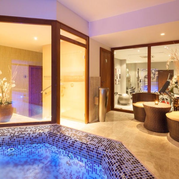 Spa area featuring cozy pool, jacuzzi, sauna and steam room.