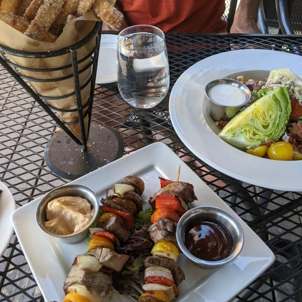 The food and drinks were very good. The setting was beautiful. The service was a little slow. Overall a good meal. Came at happy hour and had the steak skewers, the truffle fries and the wedge salad.