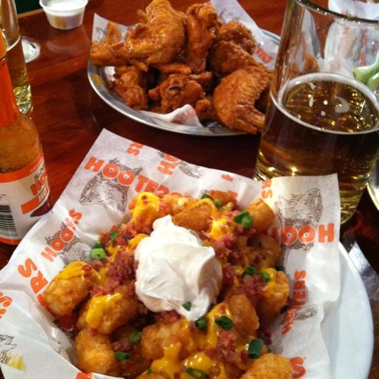Photo taken at Hooters by Julio R. on 12/22/2012