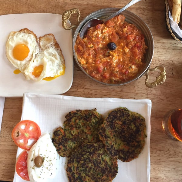 A perfect breakfast for two: Mucver (zucchini patties) with sunny side up eggs, Menemen (eggs in a pan) and pistachio baklava for dessert with Turkish coffee or tea.