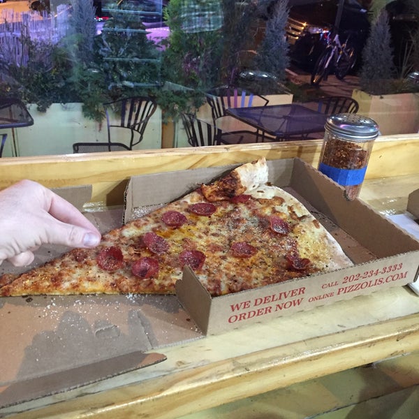 Photo taken at Pizzolis Pizzeria by Chris P. on 12/30/2015