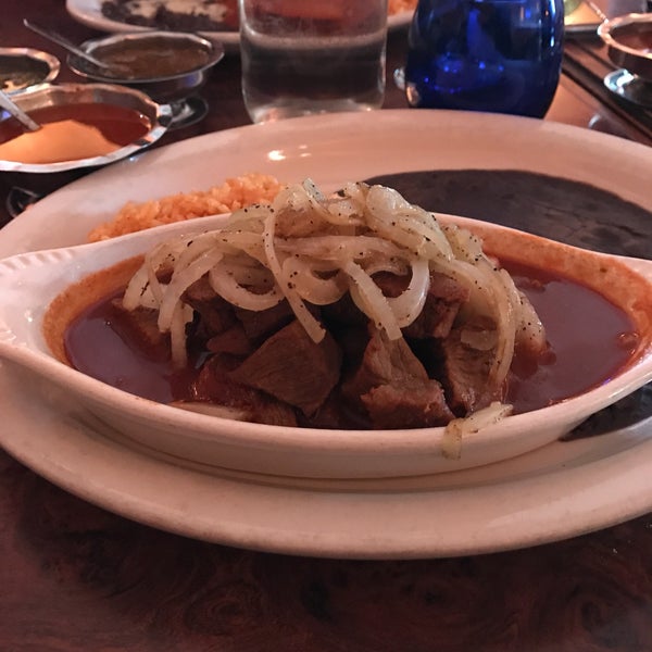 Try the Sonora (Chile Colorado)! Lean pieces of bite-size beef braised in a delicately puréed sun-dried peppers and herbs sauce. Rings of raw (or sautéed) onions on top. Amazingly tender!