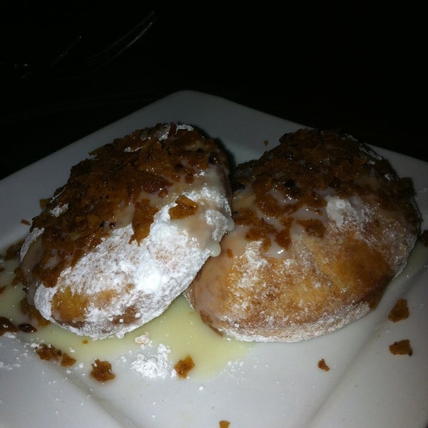 Beignets topped with condensed milk and pork belly crisps
