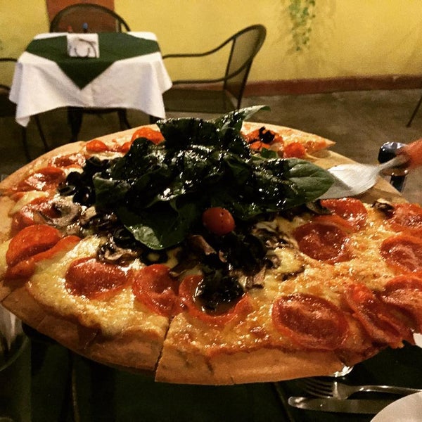 Photo taken at Osteria Marguerita. Pizza a La Leña by Rafael C. on 1/27/2016
