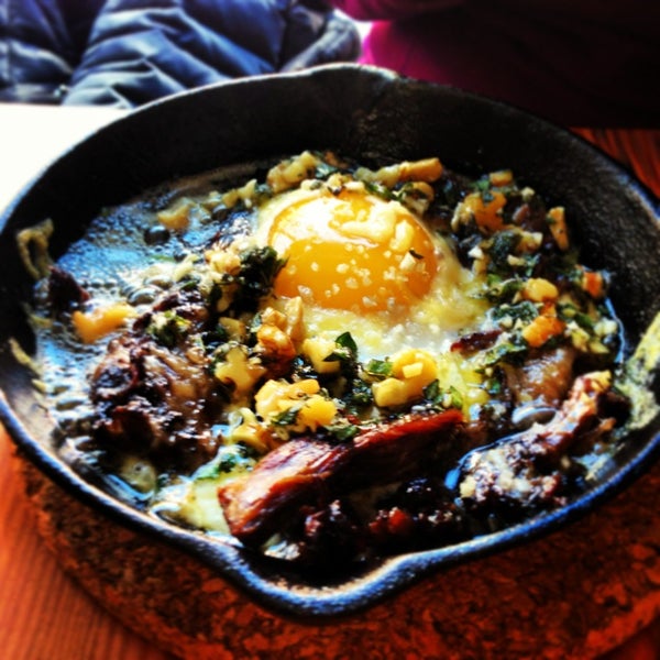 Brunch choice: skillet-baked duck egg over braised oxtail ragout with Aged Bloomsday, Oregano Pistou. Delicious.