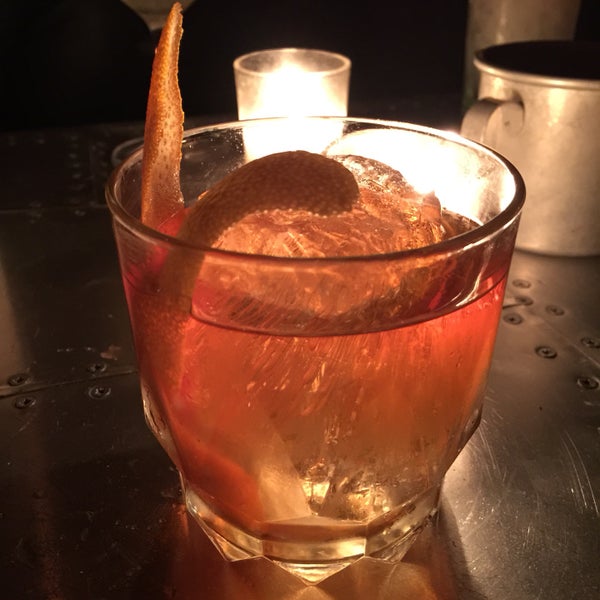 Despite the enticing concoctions offered, you can always measure a bartender's skill with an old fashioned. Here it's expertly mixed with skillfully carved ice.