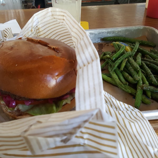 The america burger with green beans and lemonaid.