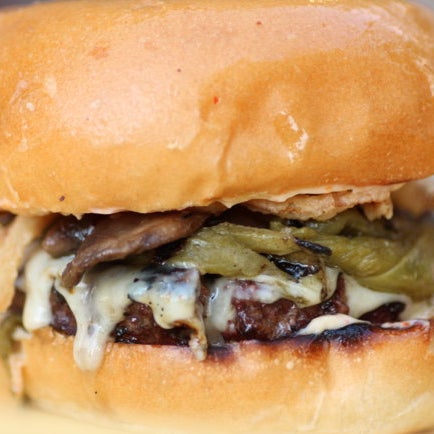 Green chile is beloved in CO, which explains the long lines to eat Juicy Burgers & Dogs' Green Chile Char-Burger, a grass-fed patty accompanied by roasted chiles, pepper jack, and onion strings.