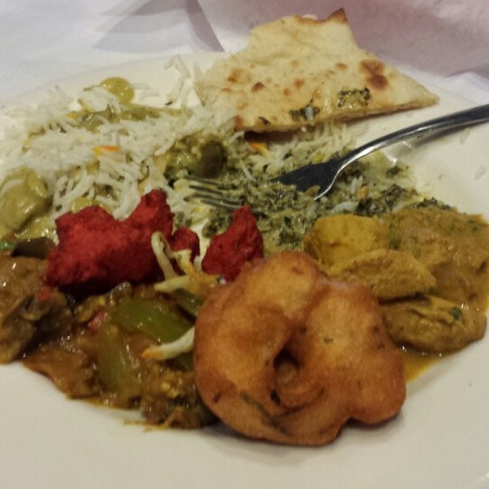 Photo taken at Mogul Indian Restaurant by Christopher M. on 5/10/2014