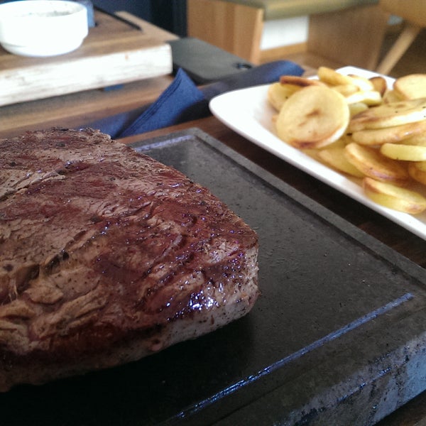 Amazing steak on a stone plate.