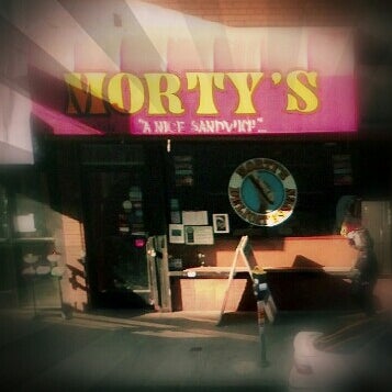 Photo taken at Morty&#39;s Delicatessen by Lil M. on 2/27/2013
