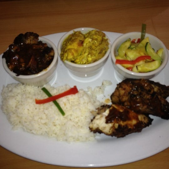 Photo taken at Jamaica Gates Caribbean Restaurant by Jules S. on 2/25/2012