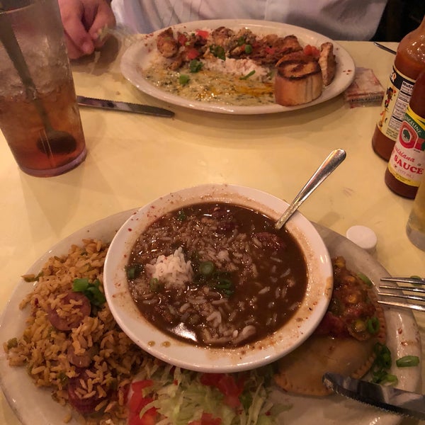 Boudain was food with some cajan power sauce . Hank Williams was bland , rice was undercooked and gumbo tasted like the bottom of a burned pot. 2 x here