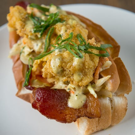 Buttermilk-soaked, deep-fried gulf oysters covered in a crust of creole-seasoned cornmeal served with — wait for it — a monster slice of bacon make the oyster roll one of CL's 100 Best Dishes.