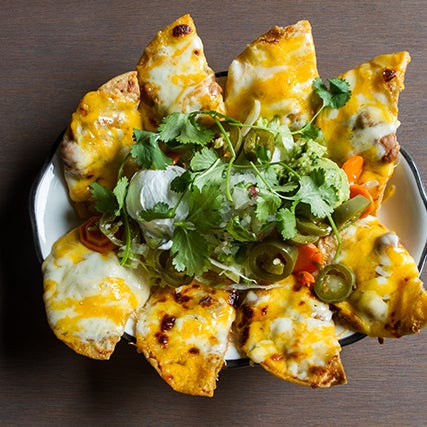 an ode to tex-mex, takes a scientific approach to nachos, piling
