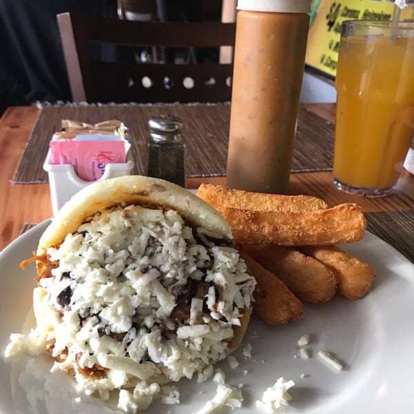 Photo taken at Arepas Cafe by Samuel B. on 3/9/2018