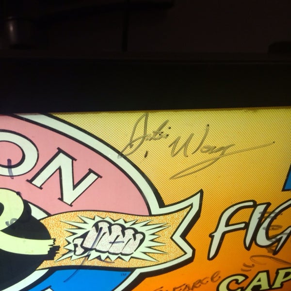 Okay, so the Street Fighter 2 Turbo machine is *signed by* Justin Wong -- SF legend and runner up World Champion. (Google "Diago Parry" or "Evo 37" for whole story)