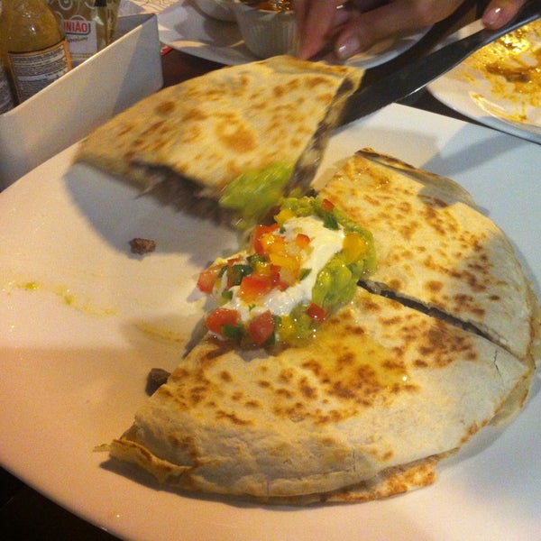Photo taken at Mucho Gusto Gastronomia Tex-Mex by Michelangela S. on 12/19/2012