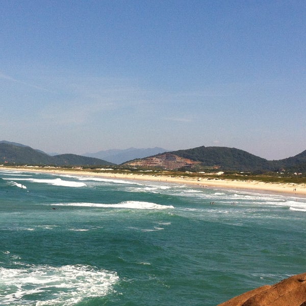 Photo taken at Praia da Joaquina by Lara Zanotto on 4/28/2013