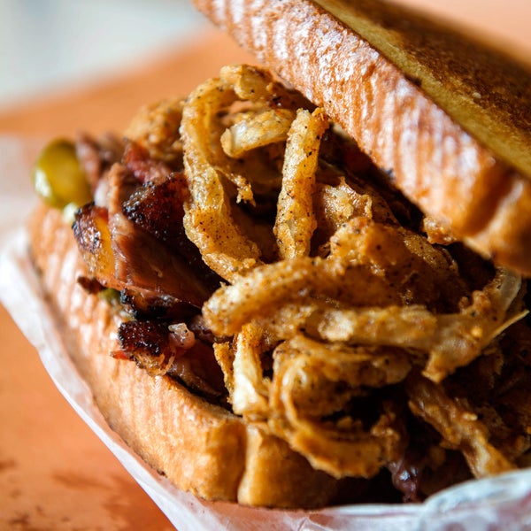 Order the Brisket Champ sandwich. It starts with 'master's level brisket' stacked onto buttery Texas toast and topped with vinegar-loaded house-made pickles and crispy buttermilk-battered onions.