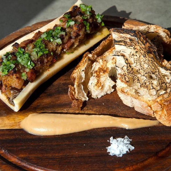 Sit at the bar and order the stuffed bone marrow, mixed with bacon  and topped with chimichurri and a streak of apple butter. Smear some on grilled bread, and enjoy with a nice glass of wine.