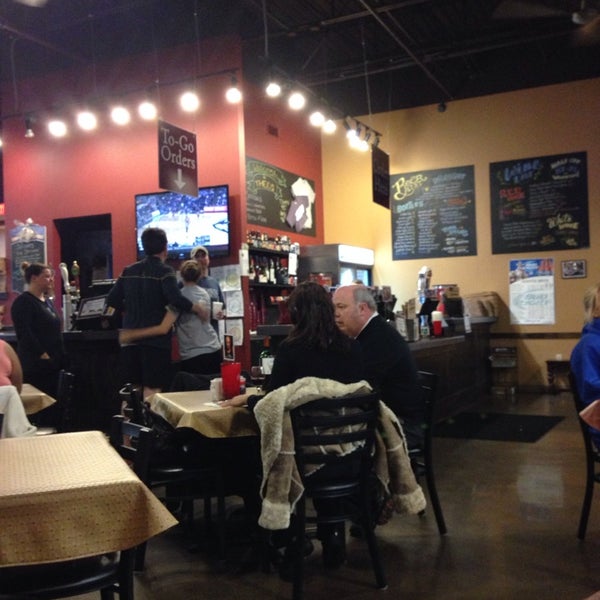 Photo taken at Theo&#39;s Neighborhood Pizza by Katie B. on 1/8/2014